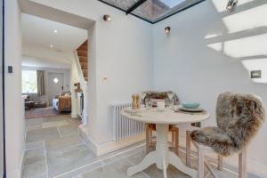 a kitchen and dining room with a table and chairs at Luxury 1 bed cottage with hot tub and log burner in Great Massingham