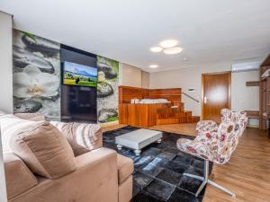 uma sala de estar com um sofá e uma mesa em Hotel Refugio da Montanha em Gramado