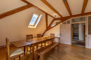 a dining room with a wooden table and chairs at Hofgut Wiggenweiler in Bermatingen