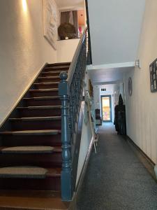 a staircase in a house with a cat sitting on the ledge at Siebenschläfer Hof in Straßbessenbach