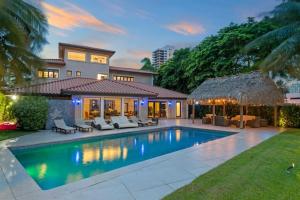 a house with a swimming pool in front of a house at Villa Toscana - Luxury with Pool in Miami