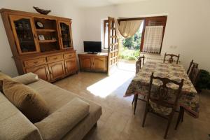 a living room with a couch and a table at Apartments Marija Savudrija in Savudrija