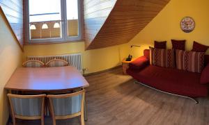 キュールングスボルンにあるFeWo Drei Moewenのリビングルーム(赤いソファ、テーブル付)
