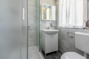 a bathroom with a sink and a toilet and a shower at Apartment Andry 2 in Crikvenica +40 photos