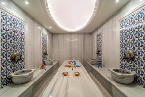 a bathroom with three sinks and a round ceiling at Sundia Exclusive By Liberty Fethiye Adults Only in Fethiye
