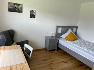 a small bedroom with a bed and a table at Landhausidylle in Simmerath +12 photos