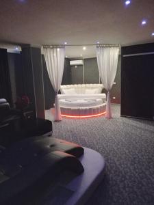 a living room with a white couch and curtains at Ely's Mansion-24h Check-in in Bucharest +15 photos