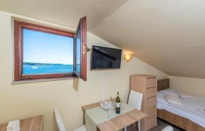 a room with a bed and a table and a window at Apartment Zeljka in Poreč