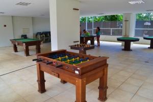 a room with several tables and billiards at Veredas Flat 325 in Rio Quente