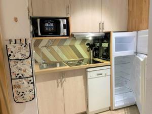 a small kitchen with a sink and a refrigerator at ANTONIA2 in Brides-les-Bains +17 photos