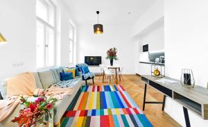 a living room with a couch and a colorful rug at Residence Dlouha - Old Town in Prague