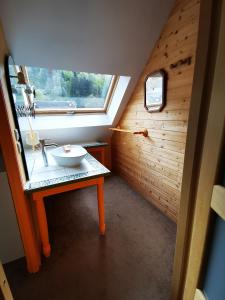a small bathroom with a sink and a window at Mirabeau in Le Mont-Dore