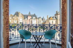 a balcony with a table and two chairs at Kereden Location in Saint Malo