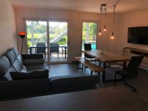 a living room with a couch and a wooden table at Ferienwohnung Bodensee 