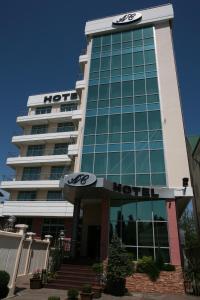 a hotel with a sign on the front of it at AC Hotel in Adler