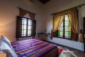 Postel nebo postele na pokoji v ubytování Riad Pacha Palace
