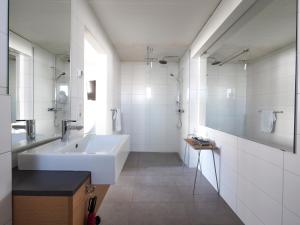 a bathroom with a sink, toilet and bathtub at Farmhouse Lodge in Vík