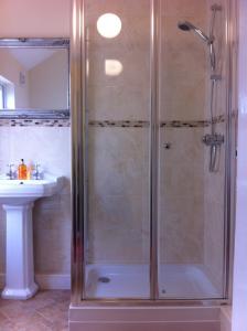 a shower stall in a bathroom with a sink at Chadwick Guest House in Middlesbrough