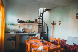 a kitchen with a bed and a staircase in a room at Altos Valles del Sol in Cafayate +22 photos