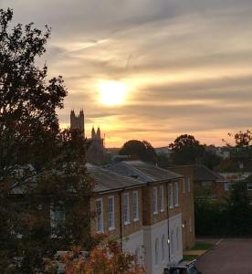 a building with the sun setting in the background at The Black Horse Inn in Canterbury