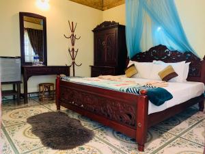 a bedroom with a bed and a desk and a mirror at Kerala cottage in Varkala