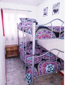 a group of three bunk beds in a room at Casa Isla Negra in Isla Negra