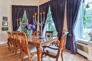 a dining room with a wooden table and chairs at Finest Retreats - Walcot Hall in Brough