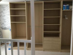 a closet with shelves and a bed in a room at Hébergement à l'Orée des Champs in Rethel