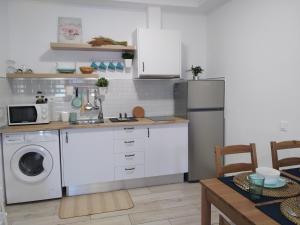 a kitchen with a refrigerator and a washing machine at Apartamento Ajuy in Ajuy