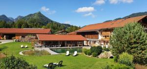 a house with a yard with a pool and a resort at Zeller Hof in Ruhpolding