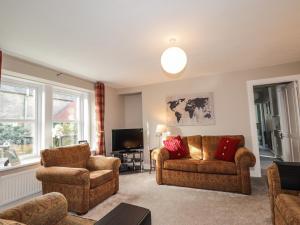 a living room with two couches and a tv at 62 Society Street in Nairn