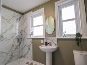a bathroom with a sink and a mirror at 62 Society Street in Nairn +22 photos