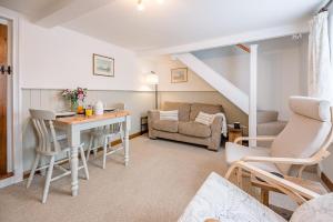 a living room with a table and a couch at North Cottage, Alderton in Woodbridge