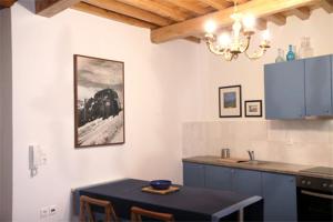 a kitchen with a table and a counter top at Stone Mansion House in Skopelos Town