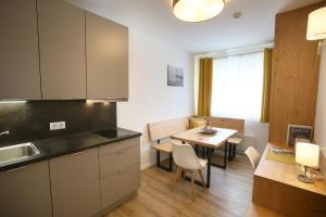 a kitchen and dining room with a table at Apartments Freitag - H1 in Winden am See