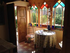 a room with a table and some stained glass windows at B&B U Kaplicky in Všelibice