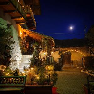 een gebouw met een verlichte binnenplaats 's nachts bij Maison Du-Noyer Chambres et Tables d'Hotes in Aosta