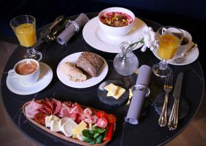 a table topped with plates of food and drinks at Noble Boutique Hotel - Adults Only in Budapest