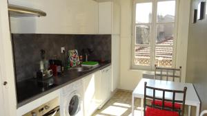 a kitchen with a sink and a washing machine at My Apartment-Metz in Metz