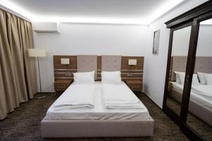 Un pat sau paturi într-o cameră la White Residence