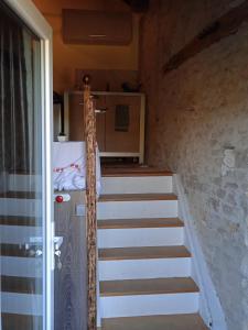 a staircase leading up to a room with a kitchen at Loft vintage avec cuisine intégrée in Pouilly-en-Auxois