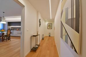 a hallway leading to a kitchen and a living room at Luxury Suites Joy in Cefalù in Cefalù