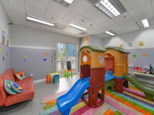 a childrens play room with a slide and a couch at Great Apartment in Brickell in Miami