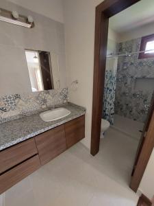 a bathroom with a sink and a shower at Quinta San Felipe in Tababela