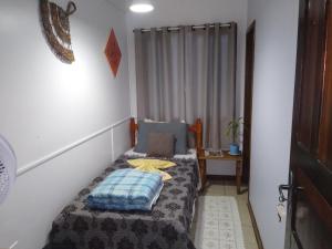 a small bedroom with a bed in a room at Pousada Joinville in Joinville