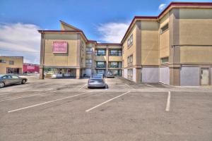 a car parked in a parking lot in front of a building at The Glengate Hotel & Suites in Niagara Falls
