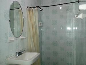 a bathroom with a sink and a mirror and a shower at Hotel San Andres in Xalapa +17 photos