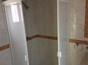 a shower with a glass door in a bathroom at Depa 2 recamaras Coyoacán in Mexico City +7 photos
