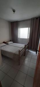 a bedroom with two beds and a window at Minha Casa, Seu Hostel in Recife