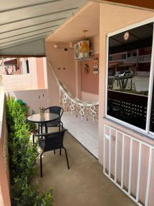a patio with a table and chairs on a balcony at Apartamento Mobiliado em Petrolina - Recomendado! in Petrolina